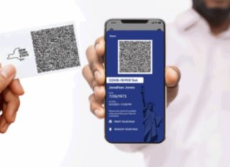 a hand holding a phone with a qr code