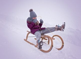 a person on a sled in the snow