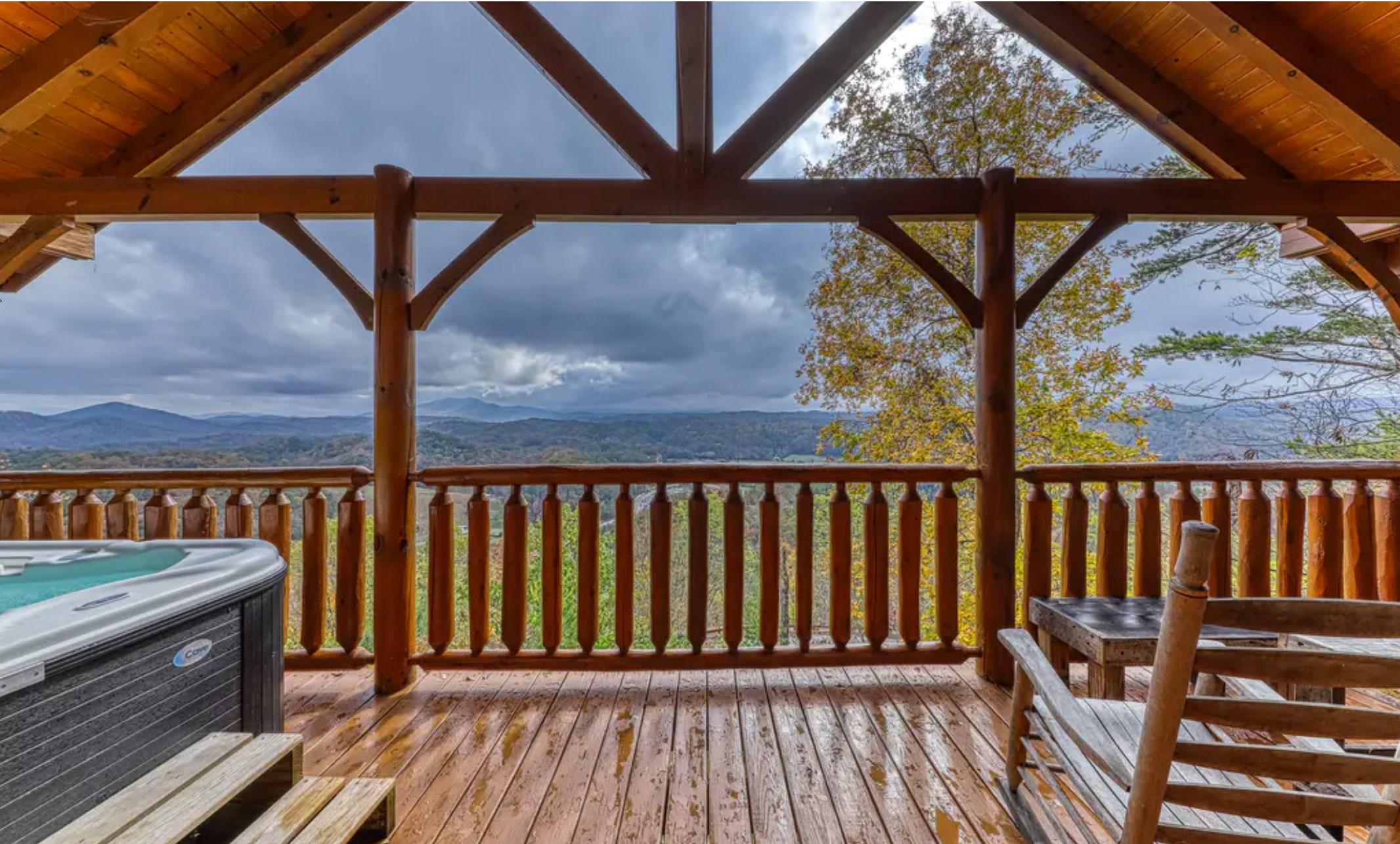 a wooden deck with a view of the mountains