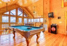 a pool table in a log cabin