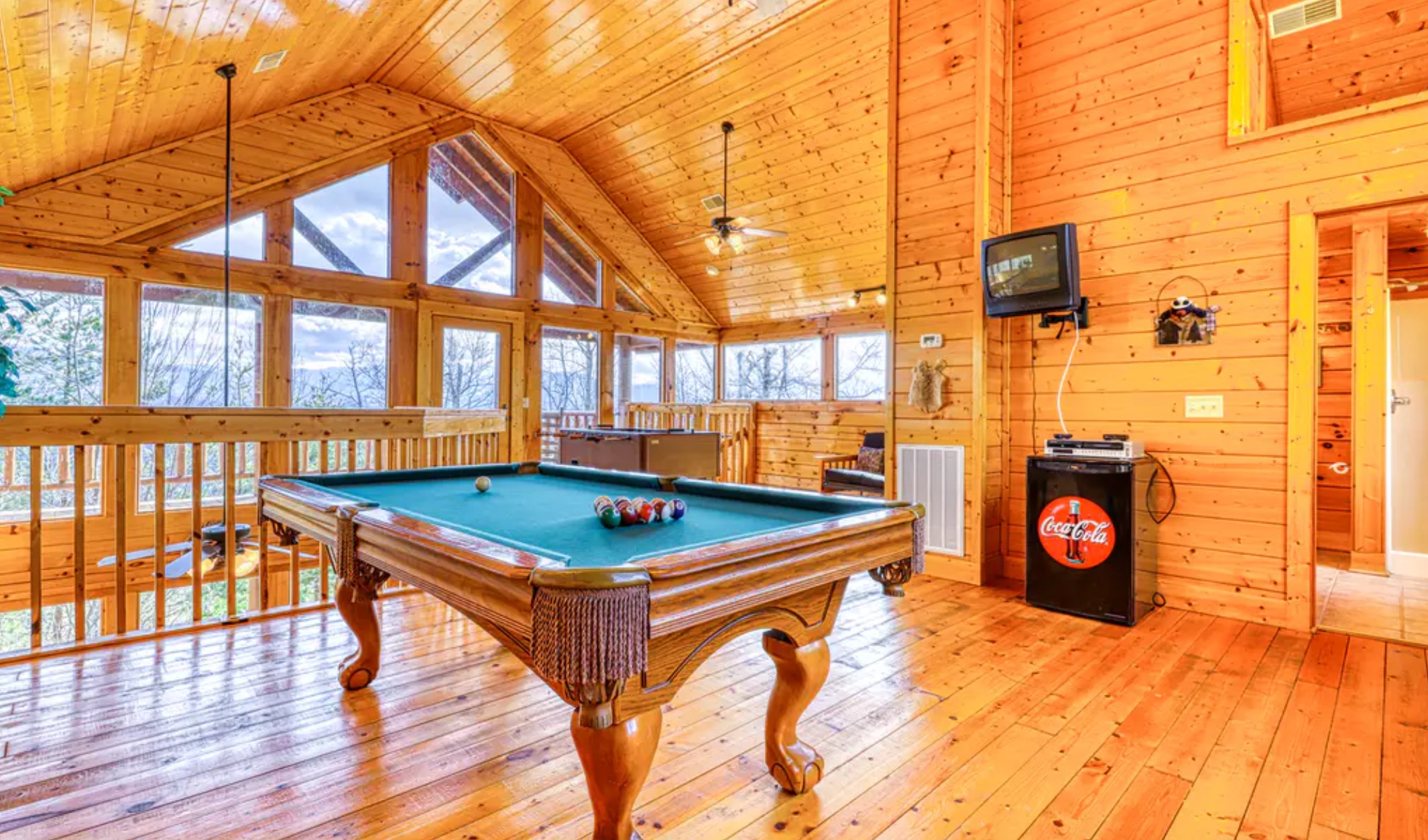 a pool table in a log cabin