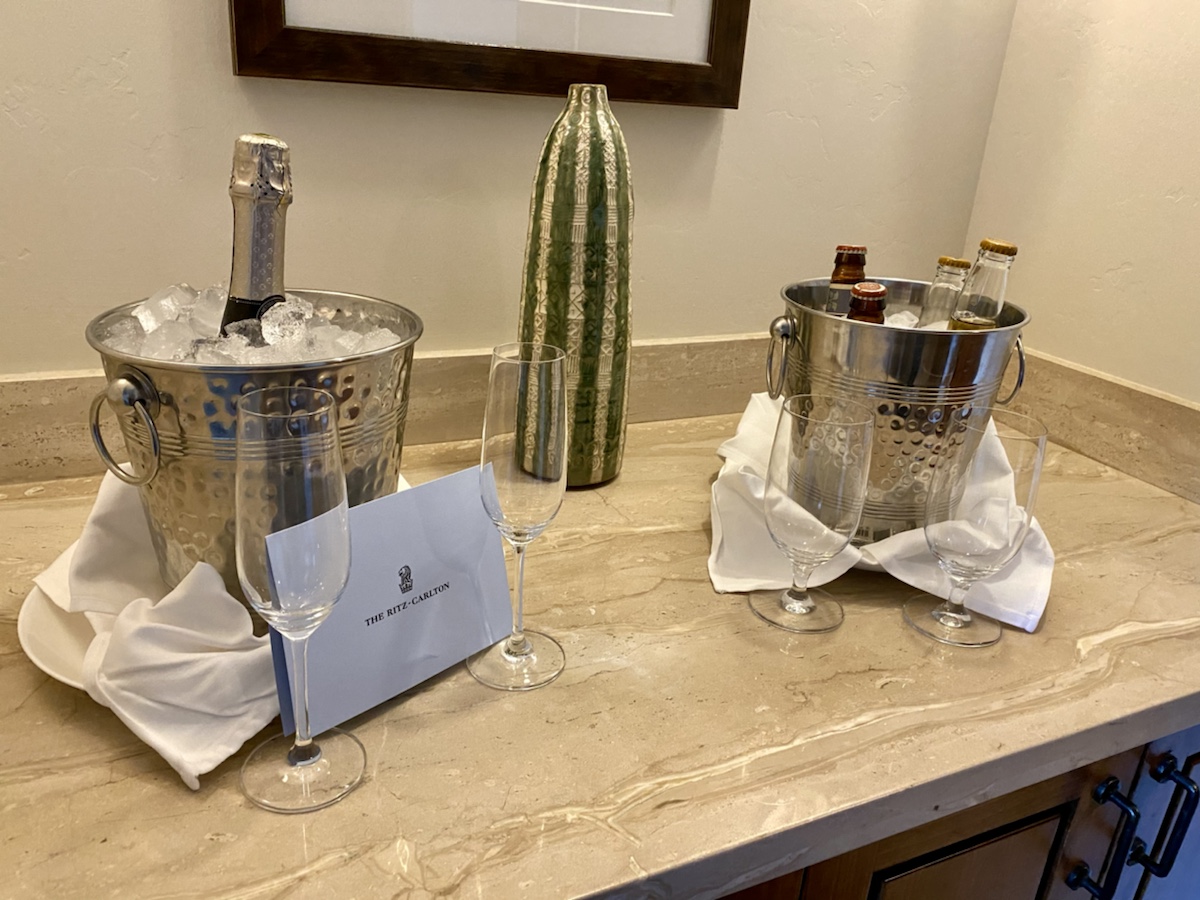 a champagne bottle and wine glasses on a counter