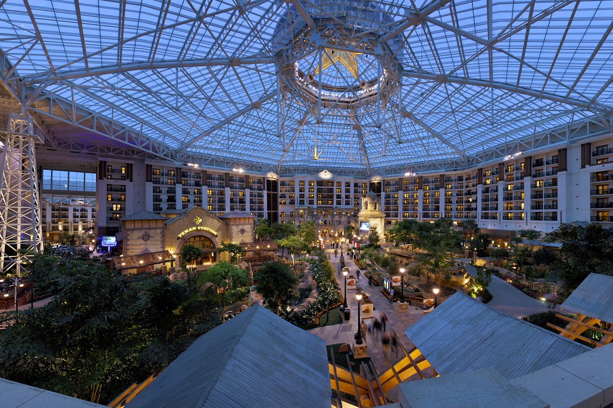 a large indoor courtyard with trees and buildings