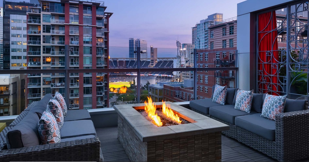 a fire pit on a deck with a city view