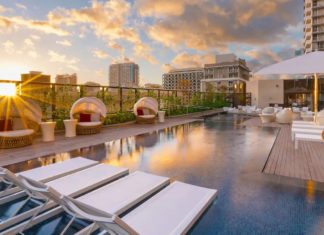 a pool with chairs and a roof top