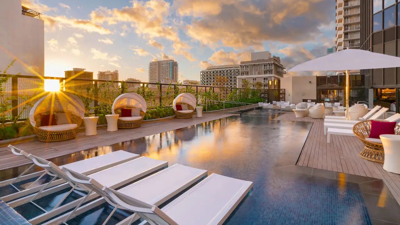 a pool with chairs and a roof top