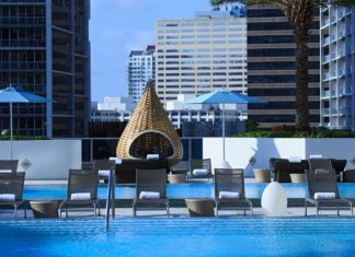 a pool with chairs and umbrellas