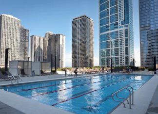 a swimming pool with a city skyline in the background