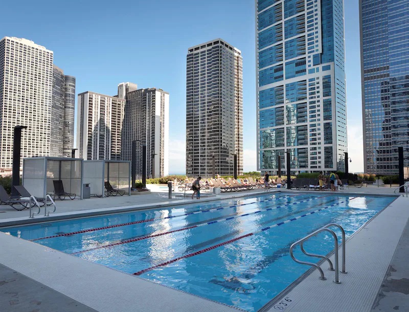 a swimming pool with a city skyline in the background