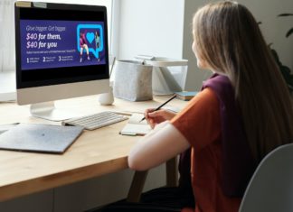 a woman sitting at a desk with a computer