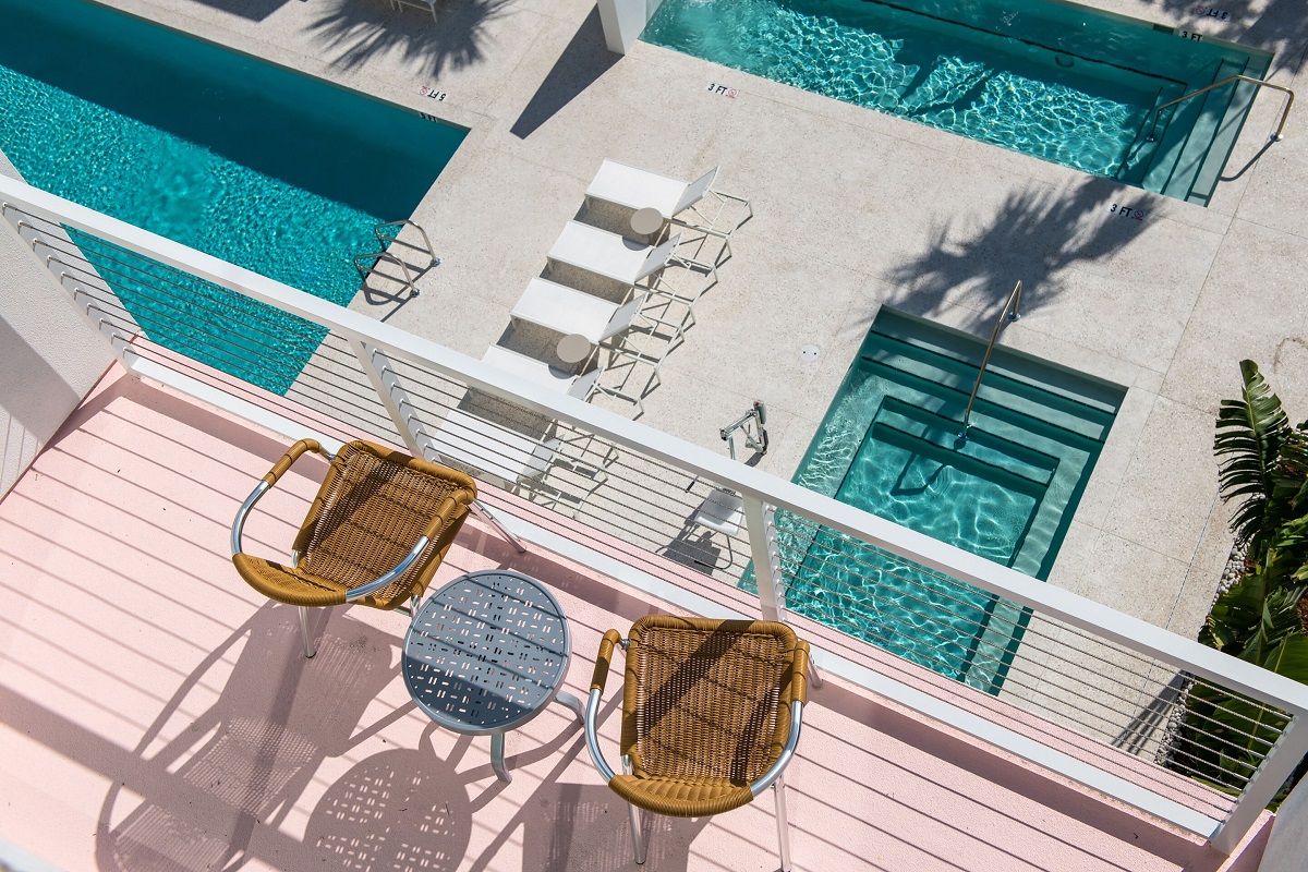 a pool and chairs on a balcony