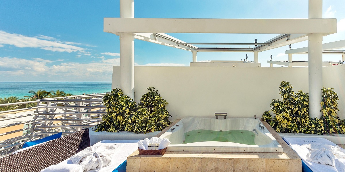 a hot tub on a rooftop overlooking the ocean