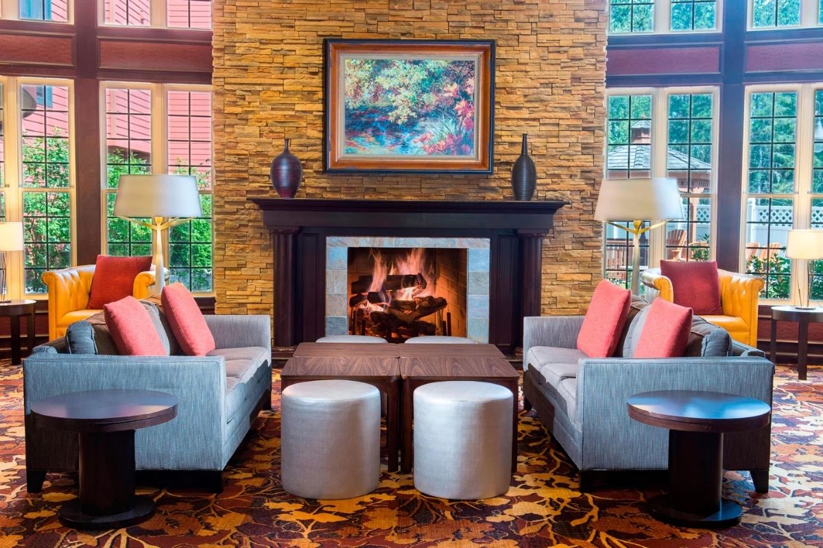 a room with a fireplace and couches