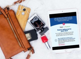 a brown purse with a tablet and a phone and a nail polish