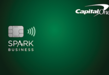 a green credit card with a chip and a logo