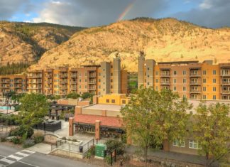 a multistory building with a rainbow in the background