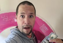 a man holding a dollar bill and a pink float