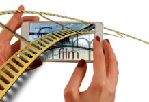 a hand holding a phone with a film strip