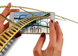 a hand holding a phone with a film strip