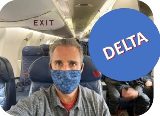 a man wearing a mask on an airplane