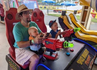 a man and two boys playing a game