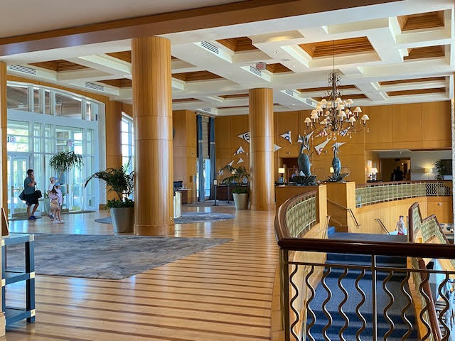 a large lobby with a chandelier and a large staircase