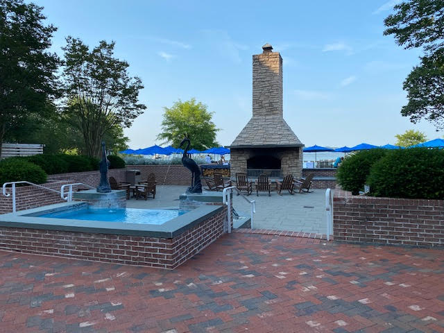 a brick patio with a fireplace and a fountain