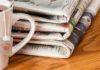 a stack of newspapers on a table