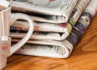 a stack of newspapers on a table