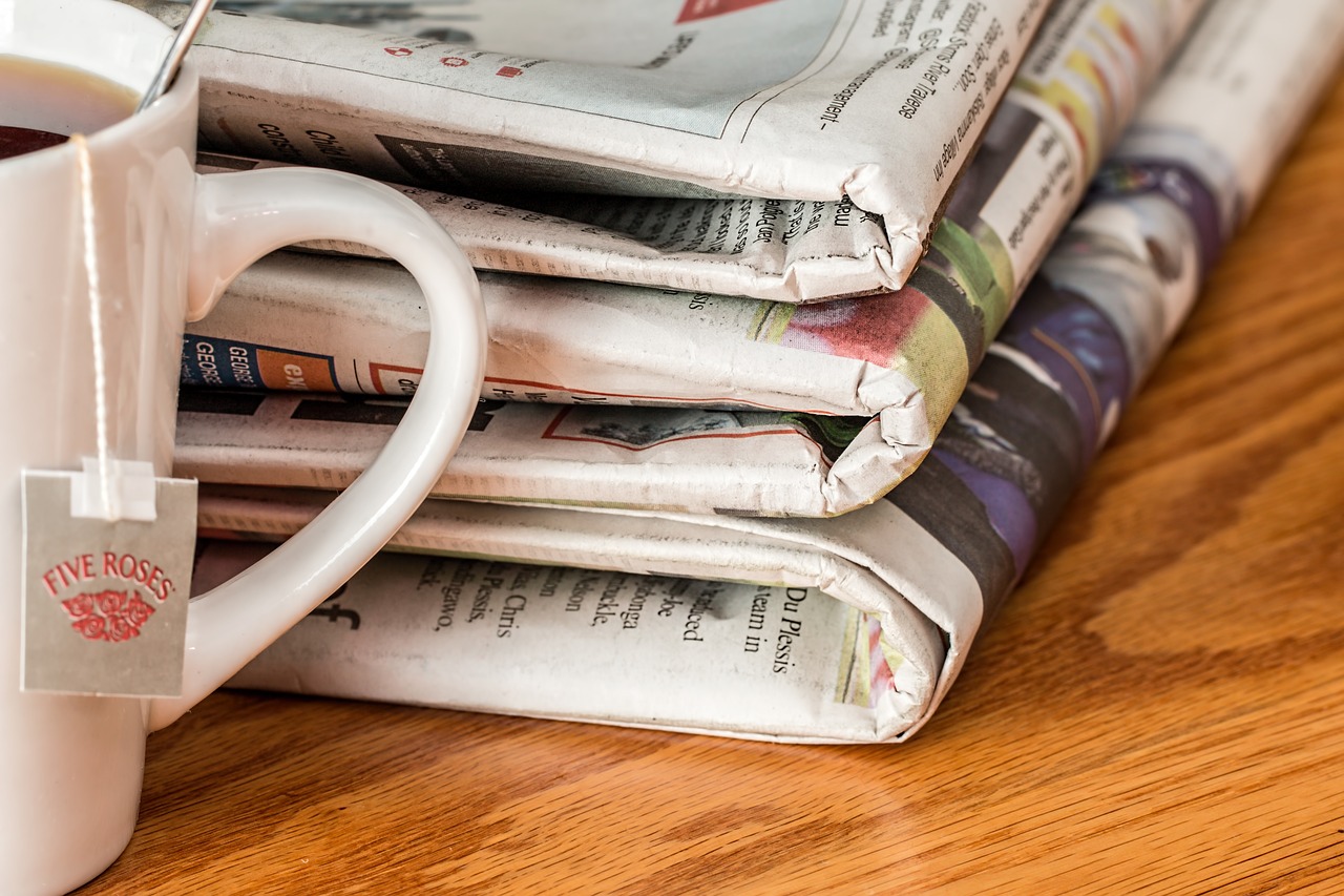 a stack of newspapers on a table