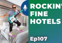 a man jumping on a bed with a guitar