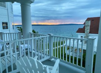 a deck with a view of the water and a beach