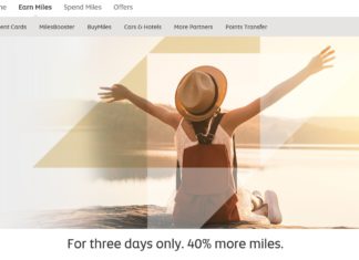 a woman sitting on a rock with her arms outstretched