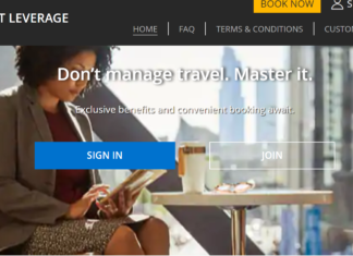 a woman sitting at a table reading a magazine