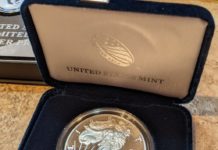 a silver coin in a box