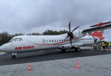 a white airplane with red writing on it