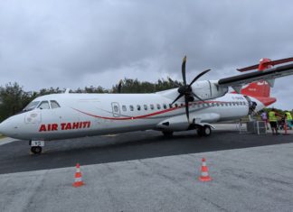 a white airplane with red writing on it