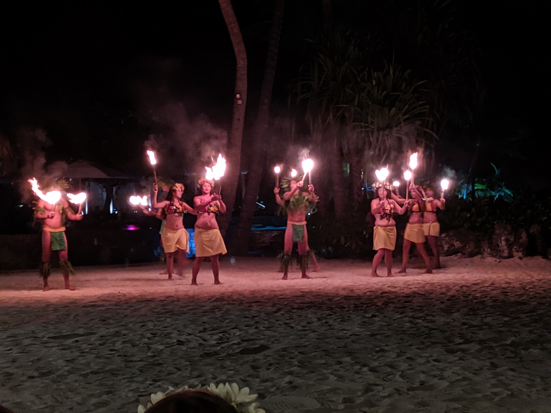 a group of people dancing on a beach