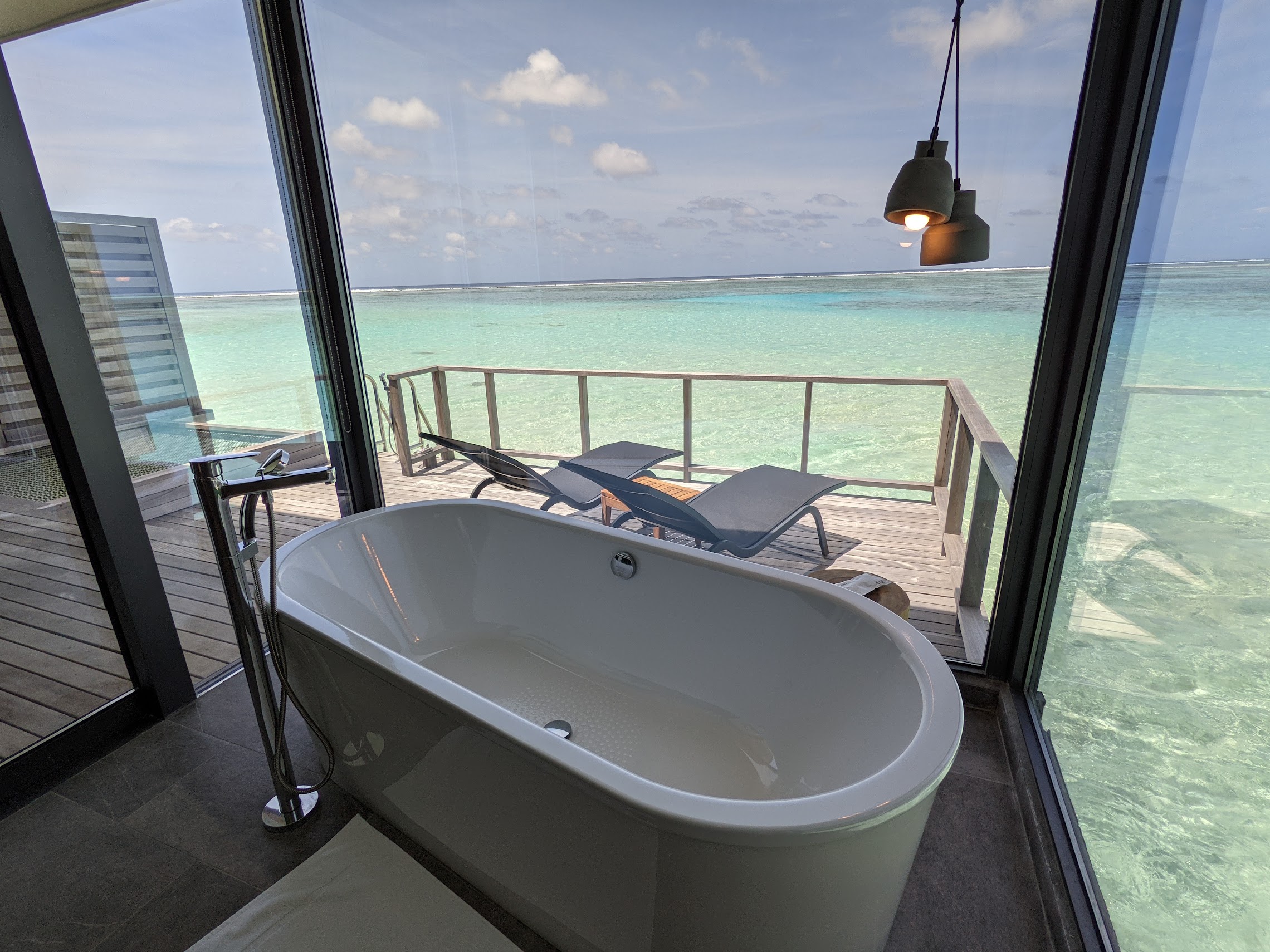 a bathtub in a bathroom with a view of the ocean