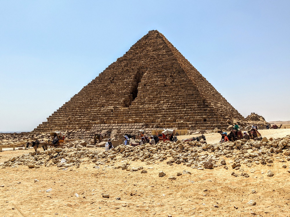 a pyramid with people in the background with Pyramid of Menkaure in the background