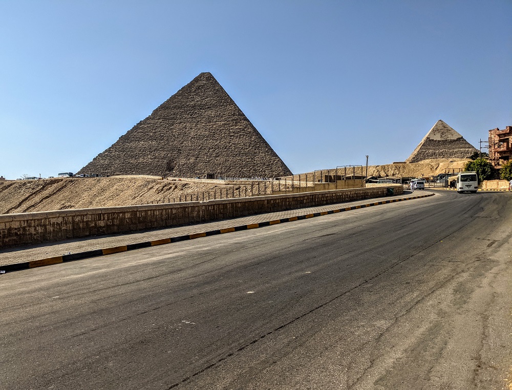 a road with a group of pyramids