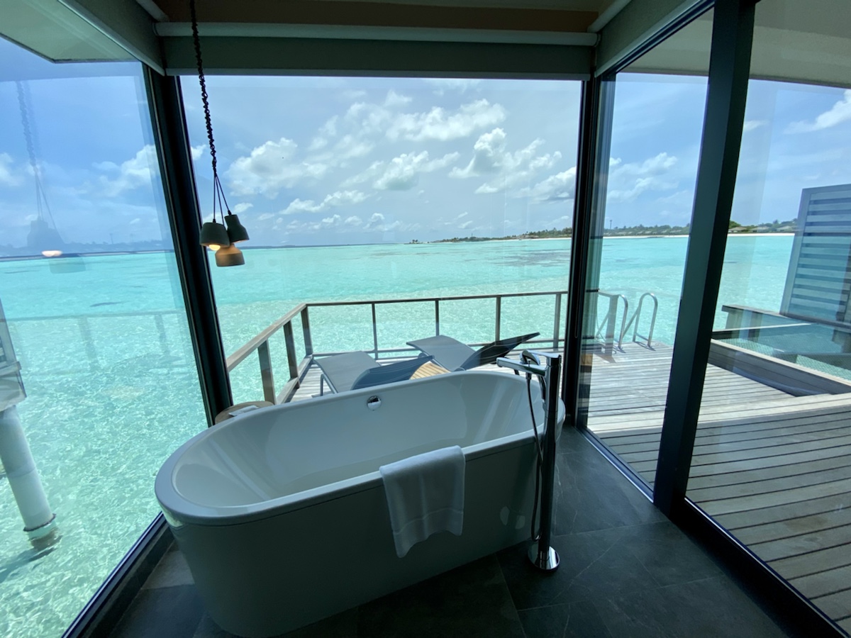 a bathtub in a room with a view of the ocean