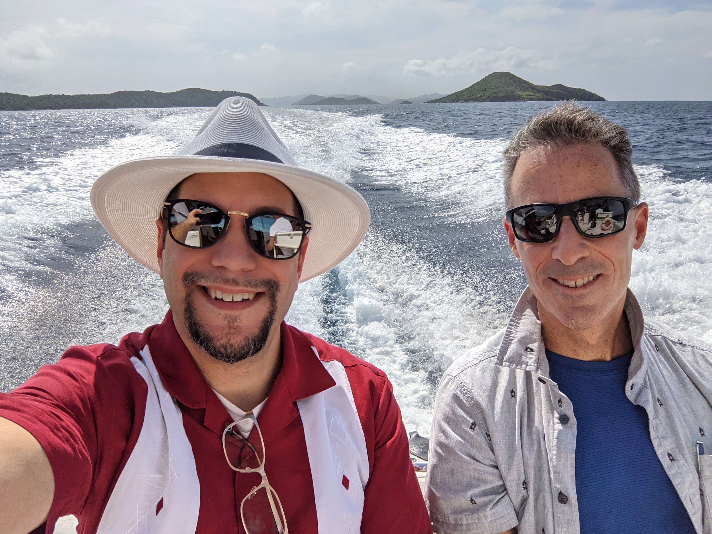two men taking a selfie on a boat
