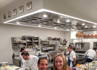 a man and woman posing for a picture in a kitchen