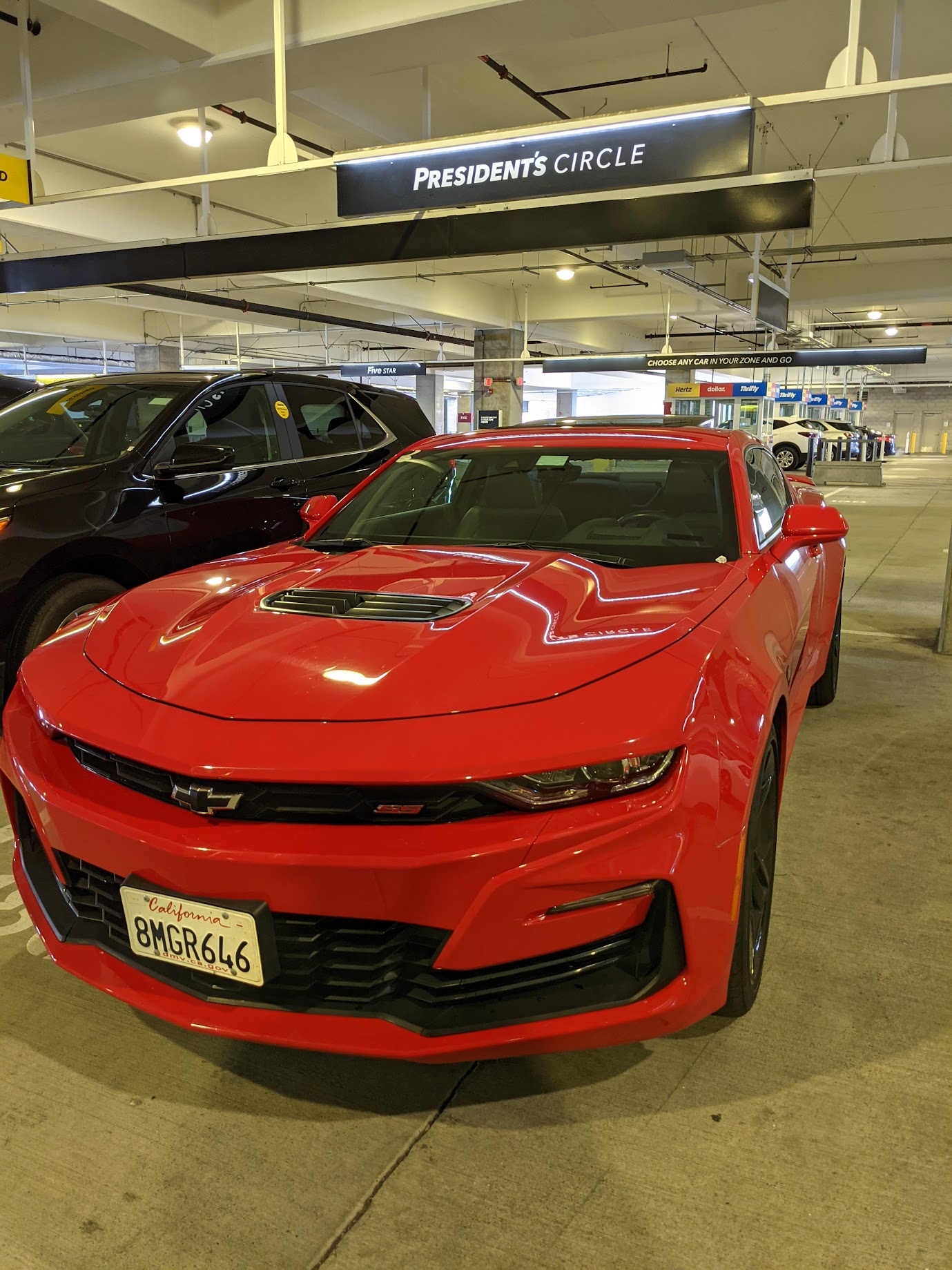 a red sports car parked in a parking lot