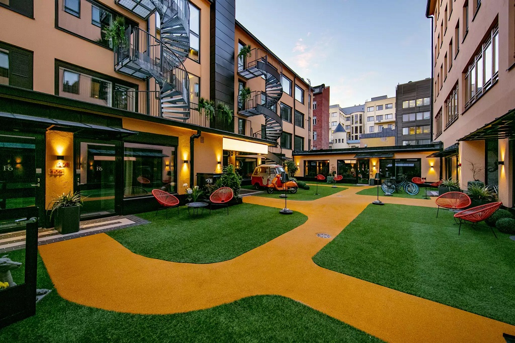 a courtyard with a spiral staircase and a yellow path