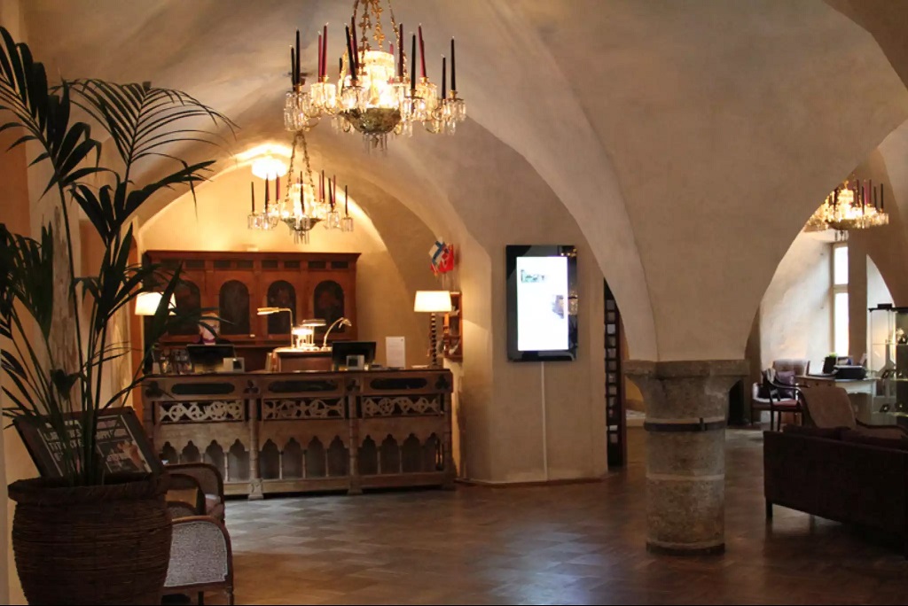 a room with a reception desk and chandelier