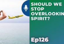 a yellow airplane flying over water