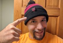 a man wearing a beanie and pointing his finger