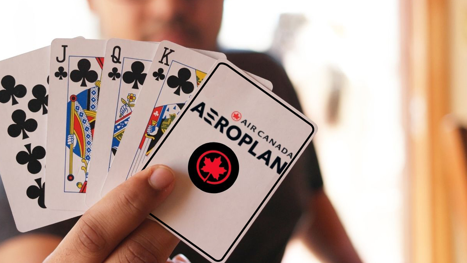 a hand holding playing cards